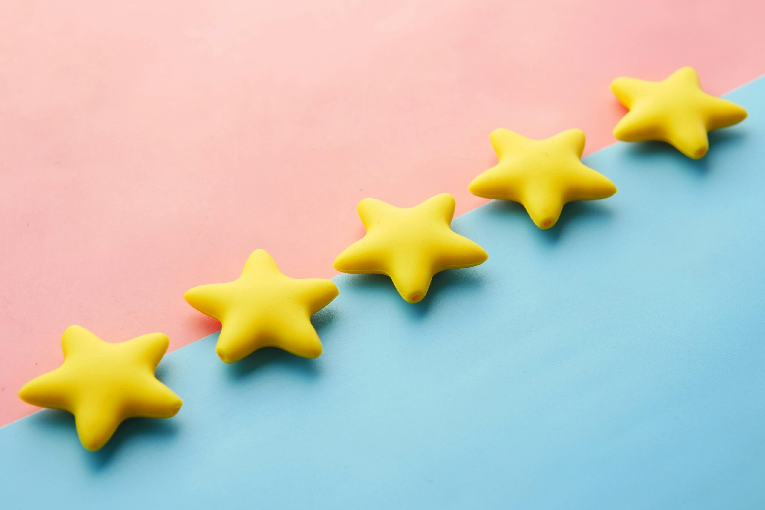 Five yellow stars on a colorful background, symbolizing positive customer reviews.