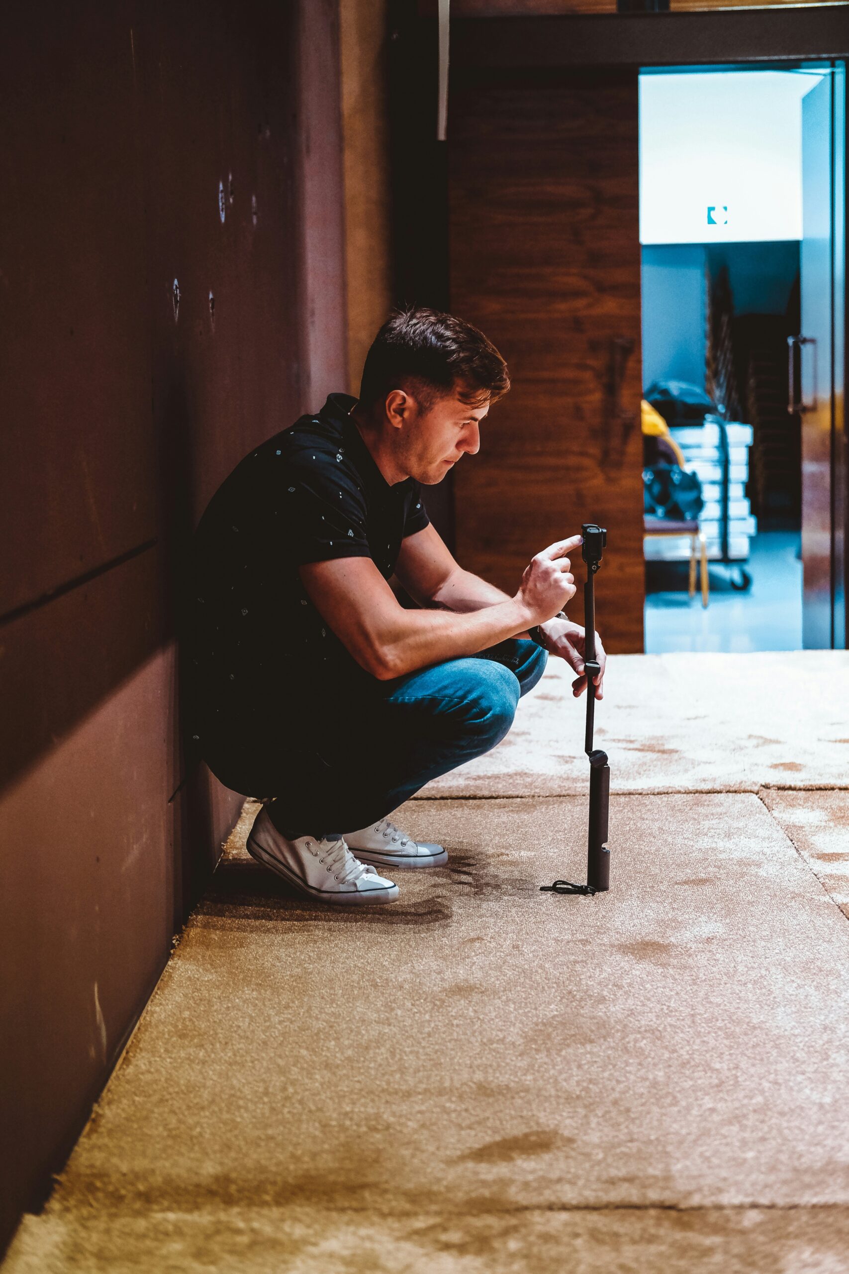 Man recording short-form video content with a smartphone stabilizer.